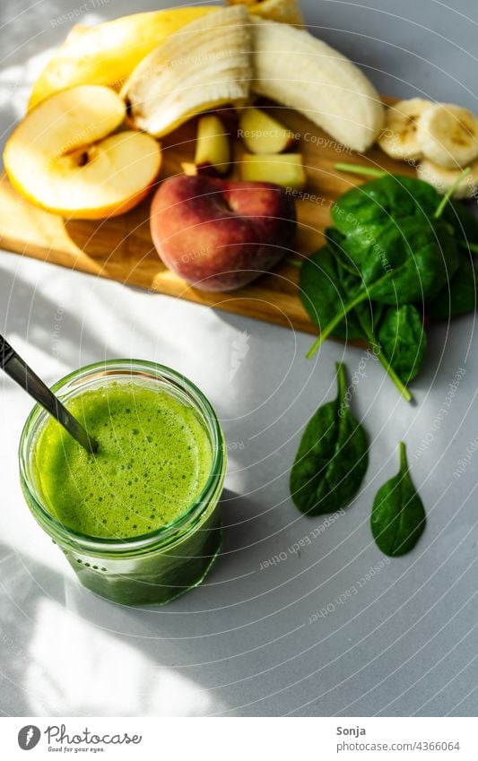 Green smoothie in a drinking glass and ingredients on a wooden cutting board fruit Vegetable Vegetarian diet Healthy Eating Self-made Chopping board