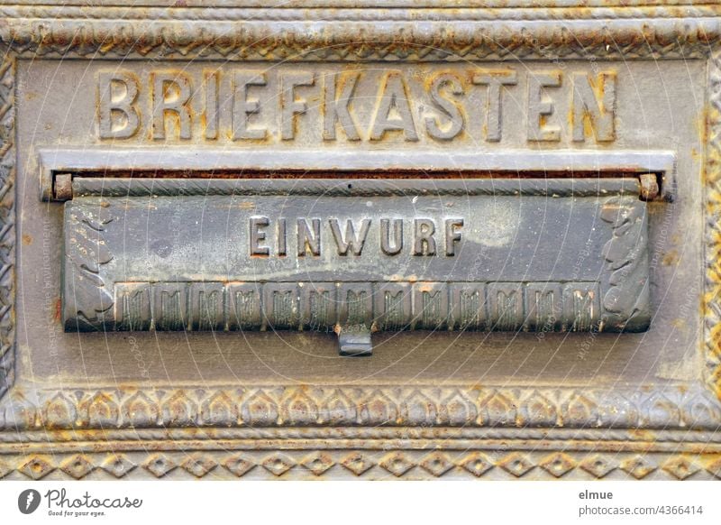Partial view of a cast-iron mailbox with ornaments and the inscription BRIEFKASTEN as well as a deposit flap with EINWURF / letter exchange Mailbox throw-in