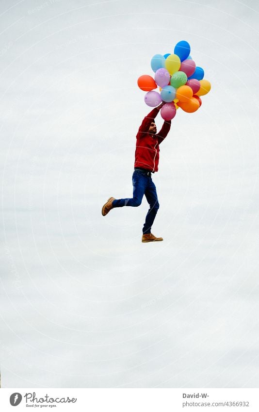 Man flies with balloons Flying Freedom Sky Success vacation Weightlessness time-out concept departure Dream