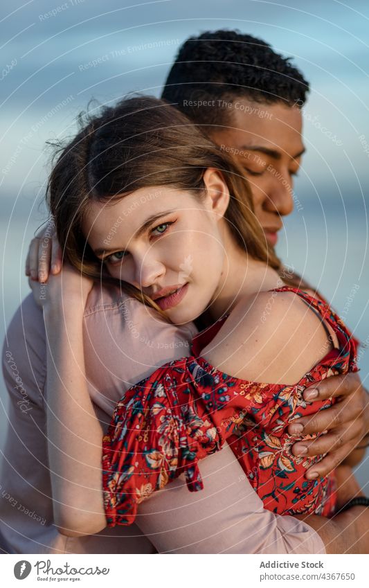 Tender multiethnic couple embracing on beach embrace love seashore tender serene hug relationship multiracial diverse black african american together affection