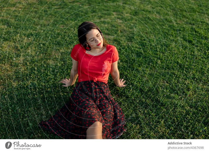 Serene woman chilling on lawn in park summer serene harmony sunset peaceful meadow enjoy female grass nature field sit calm tranquil carefree freedom