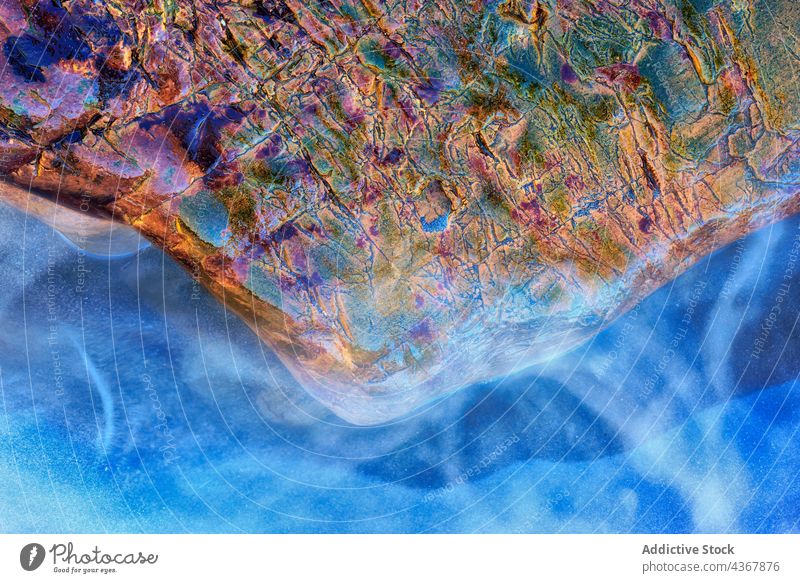 Abstract wet stone near water abstract iridescent texture background surface bright clean aqua rough colorful vivid liquid clear detail pure blue rock moisture