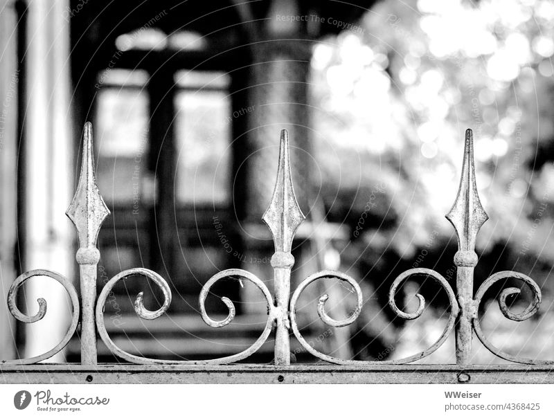 An enchanted, perhaps long abandoned house behind an ornately wrought fence Fence Ornament Curved wrought-iron obstacle House (Residential Structure) Villa Old