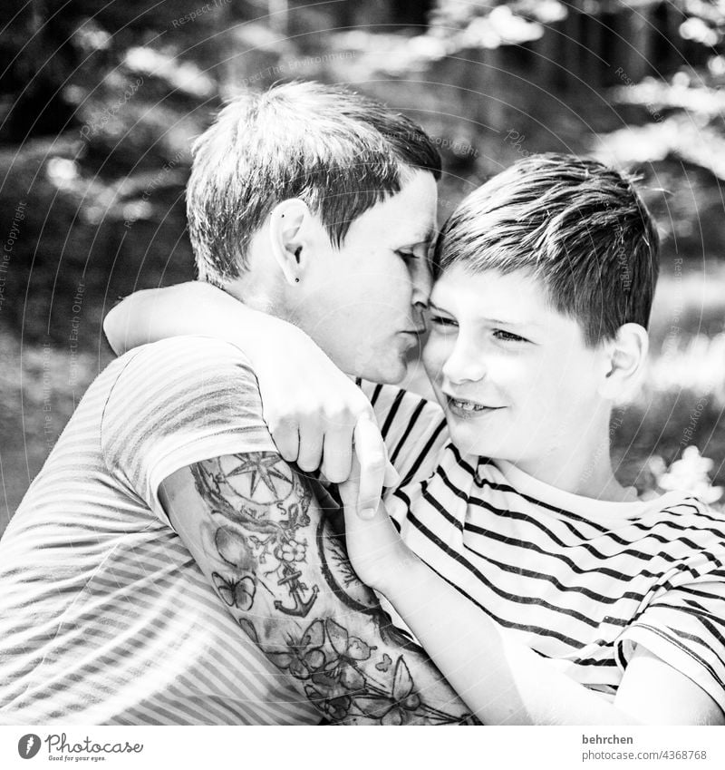 proximity Black & white photo Warm-heartedness Embrace mother and son Emotions muck about in common Safety (feeling of) Family fortunate Mother Parents