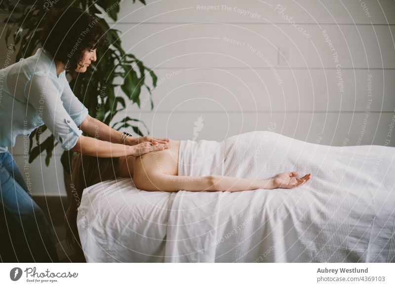 woman getting a back massage 25-30 30-35 35-39 adult balance calm exercise female hands healing health healthy lifestyle indoor life coach massage therapist