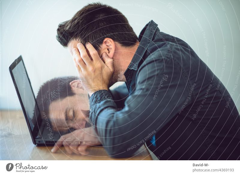 Man sits overworked, unmotivated and tired at his laptop fallen asleep home office Office Workplace Notebook Photomontage Desk unfocused overtired labour Study