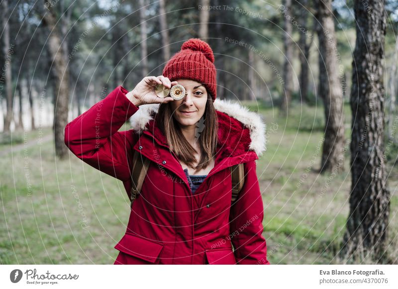 backpacker caucasian woman holding compass in front of eye in forest. Hiking and nature hiking navigation orienteering leisure guide searching hiker adventure
