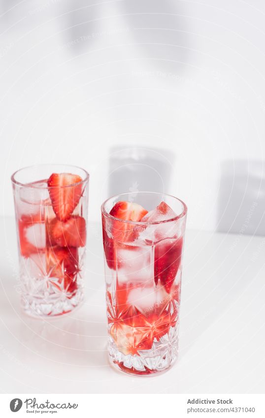 Glass with cold strawberry drink ice glass fresh infuse summer natural beverage detox refreshment delicious tasty juice vitamin healthy cube liquid serve