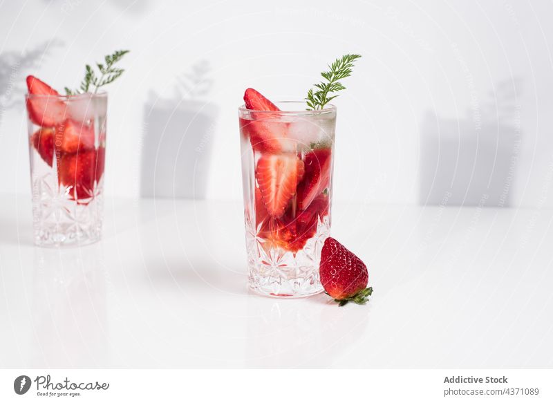 Glass with cold strawberry drink ice glass fresh infuse summer natural beverage detox refreshment delicious tasty juice vitamin healthy cube liquid serve