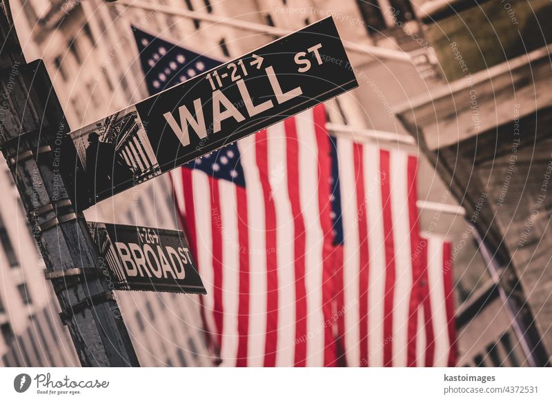 Wall street sign in New York with American flags and New York Stock Exchange in background stock exchange america banking market finance new york city nasdaq