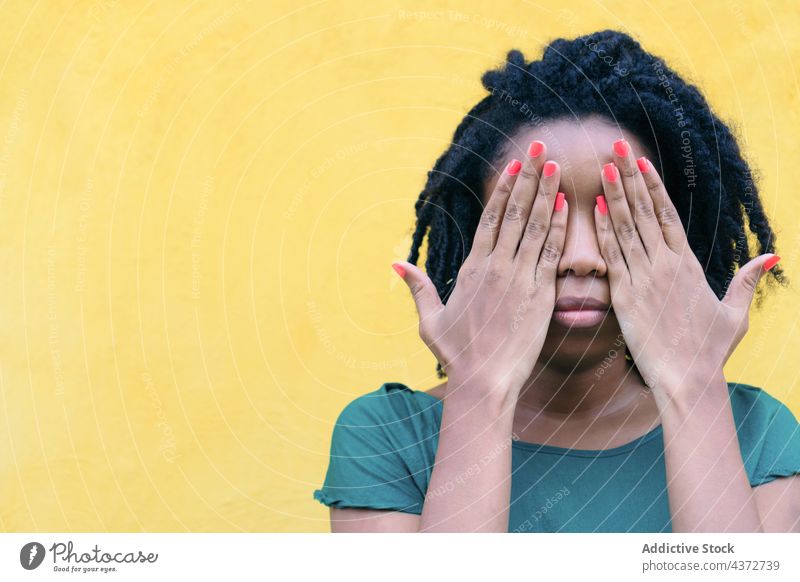 Portrait of African woman covering her eyes in the street african people happy portrait american model lady ethnicity afro female young girl outside person