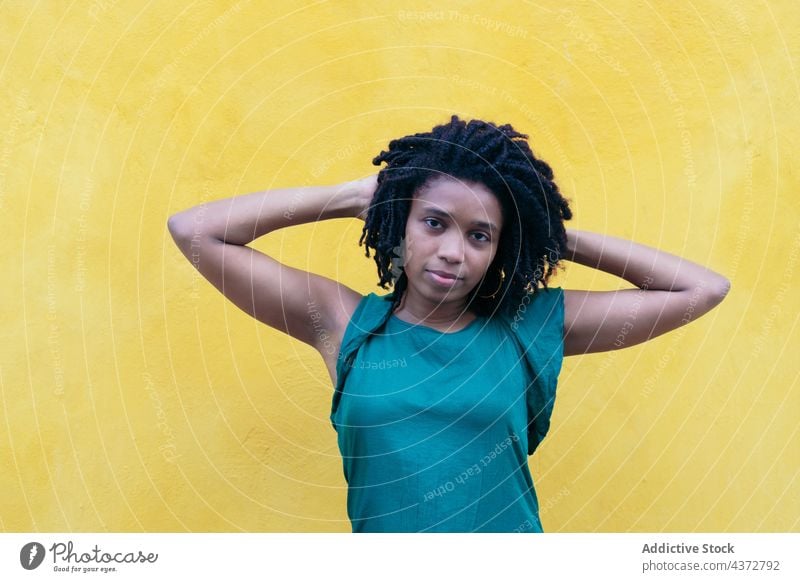 Portrait of young woman with dreadlocks in the street african people happy portrait american model lady ethnicity afro leaning beauty wall female happiness