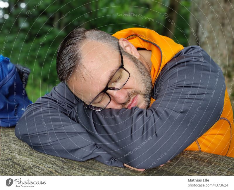 Man with glasses sleeps and rests Lie Sleep Relaxation Summer Vacation & Travel done daypack Backpack Bag sleep late travel attracted Break tired Completed