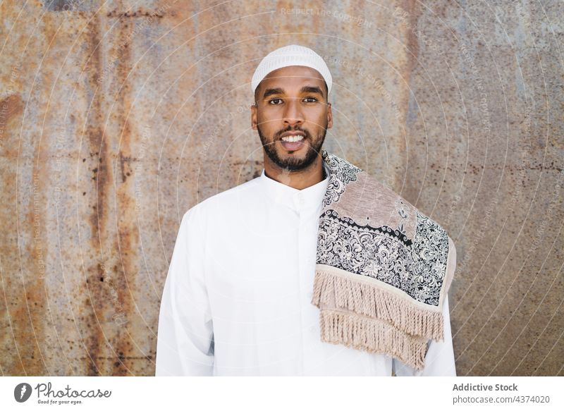 Muslim man in traditional clothes islam muslim ethnic arab portrait culture wall grunge religion garment appearance exterior male building shabby apparel cap