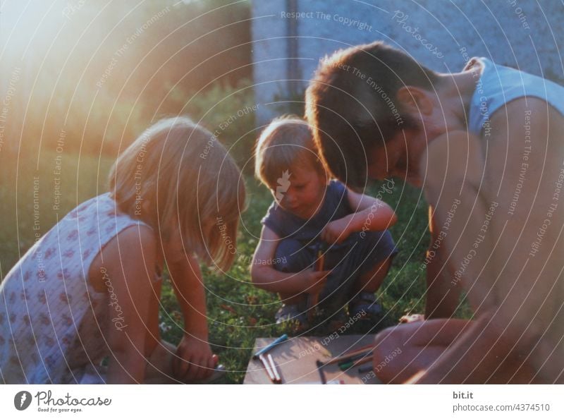 Constructive l mother painting with two children in the garden in the sunset. Mother maternity Love Infancy Lifestyle people Child Woman Together Happiness