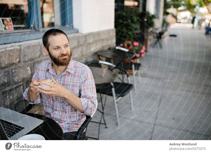 Young man  working remotely from an outdoor coffee shop 25-30 30-35 years adult american beard bearded blogger boss brunette business owner cafe california