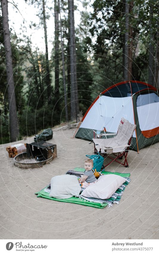 baby sitting on the ground at a tent campsite california camper camping chair child childhood daughter family fire forest fun girl happy idyllwild lifestyle