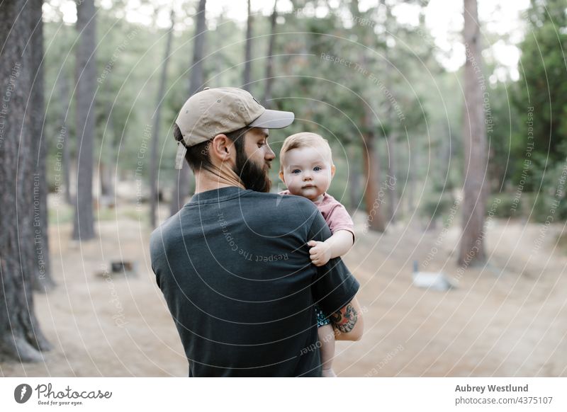 father carrying his baby daughter on a walk through the woods 25-30 30-35 30-40 beard bonding california camp camper camping campsite caucasian chair child