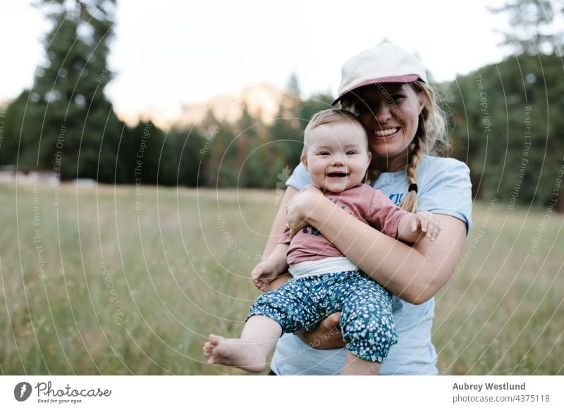 mother and baby daughter smiling in a meadow 25-30 30-35 30-40 6 months america down to earth babe beard bonding california camp camper camping campsite