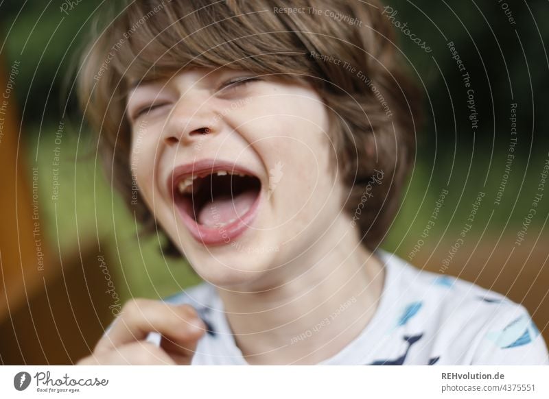 Kid laughs his head off Child Boy (child) naturally Summer bollocks Infancy fortunate Happy portrait Face Authentic fun Exterior shot 7 years