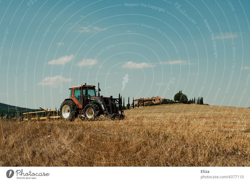 Tractor in a field in Tuscany Field Agriculture Nature Italy agriculturally Farm Rural Landscape Blue sky