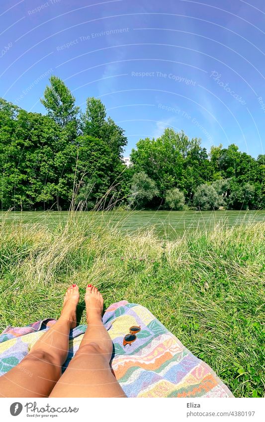 woman legs on a towel in summer sunbathing at a river in nature Legs Woman Towel Summer Sun Isar River Green Nature Body of water Water Meadow Lie Summery Naked