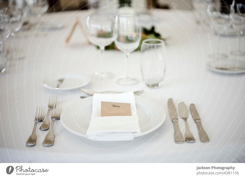 Table setting in a fancy restaurant table plate glass wedding posh clean formal menu utensil dinnerware stylish shiny elegance catering wineglass tableware