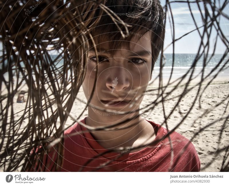 Close-up portrait of a boy on the beach close-up youngster child kid tourist tourism travel vacation holiday summer teen teenager 13 years sea landscape serious