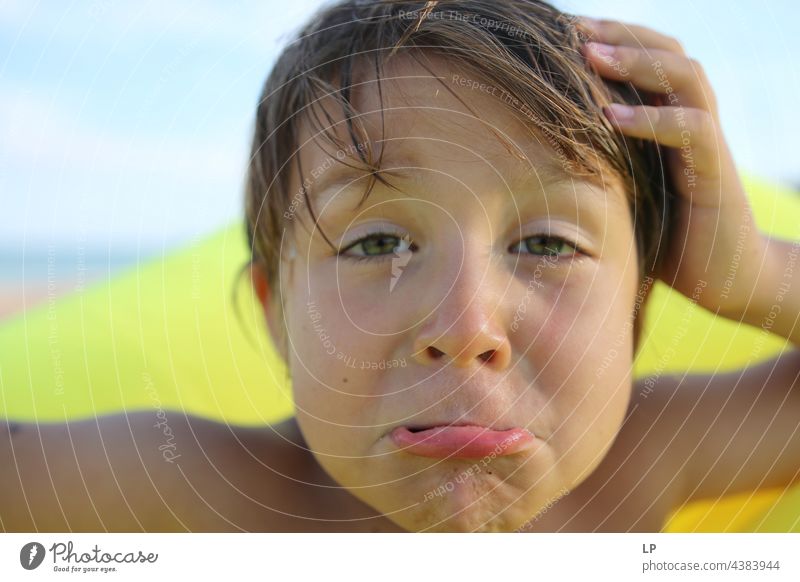 child looking puzzled at the camera and making a face Looking into the camera Upper body Portrait photograph Copy Space right Copy Space left Cool (slang)