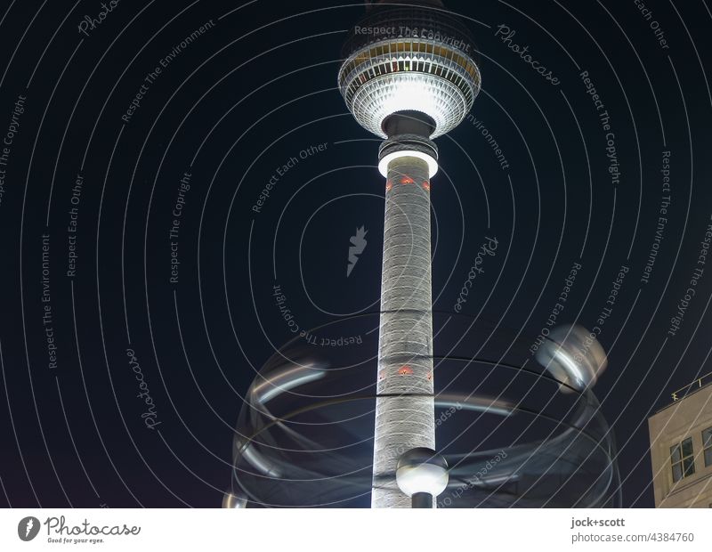 The world time clock turns at night in front of the TV tower World time clock Alexanderplatz Meeting point Berlin TV Tower Capital city Tourist Attraction