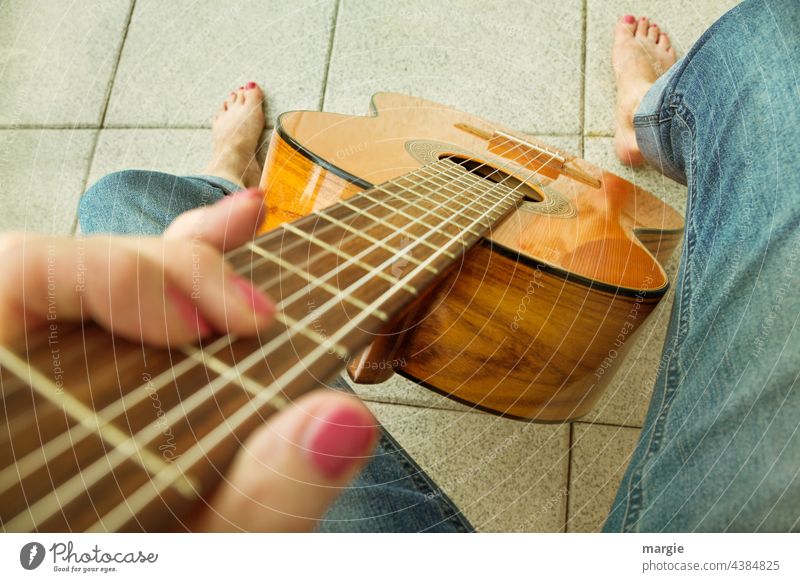 A woman plays guitar barefoot Guitar Music Musical instrument string Detail Feet Barefoot String instrument Leisure and hobbies Close-up Shallow depth of field