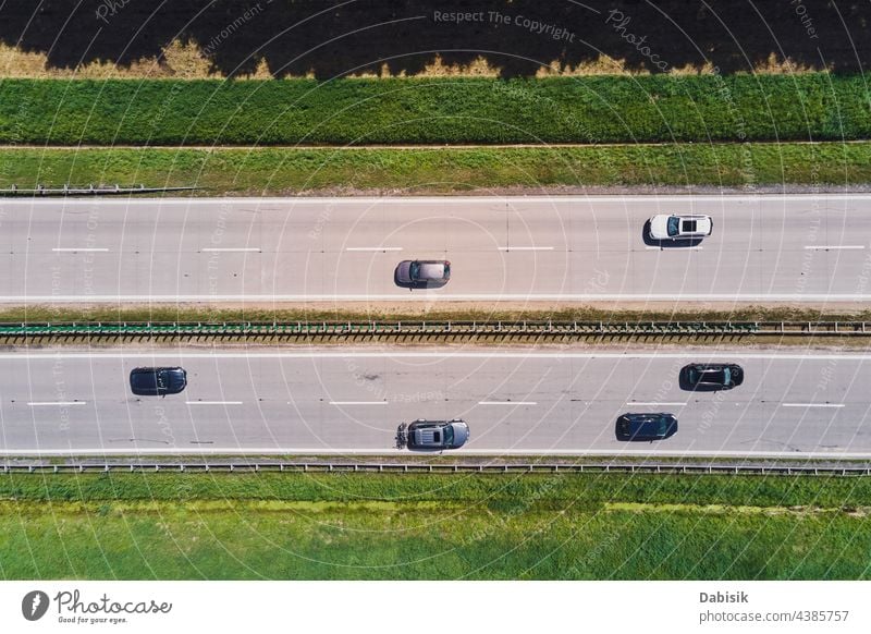 Aerial view of highway with moving cars. Road traffic road transport aerial travel transportation logistic asphalt landscape tree background top street country