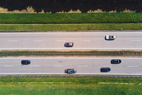 Aerial view of highway with moving cars. Road traffic road transport aerial travel transportation logistic asphalt landscape tree background top street country