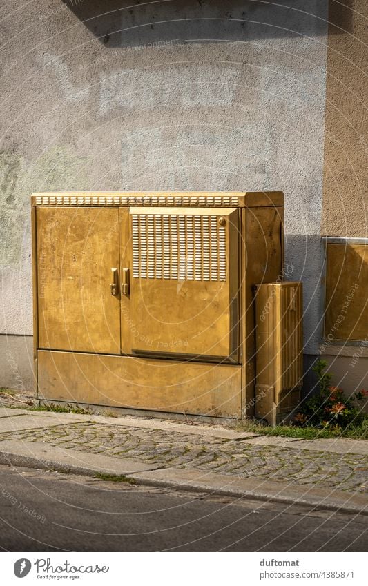 Power box in gold on house wall in Dresden-Neustadt Gold power box Wall (building) urban Joke wittily Exterior shot downtown Street off wayside Paving stone