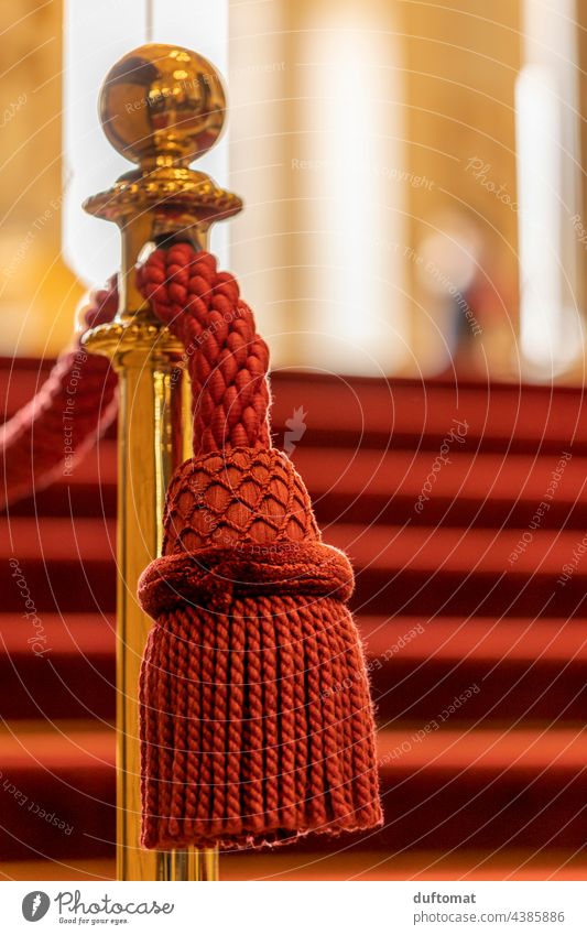 Noble red tassel hangs from golden barrier Opera rail Red Close-up Tuft Hang Detail Decoration Stairs handrail Upward Staircase (Hallway) Architecture Metal