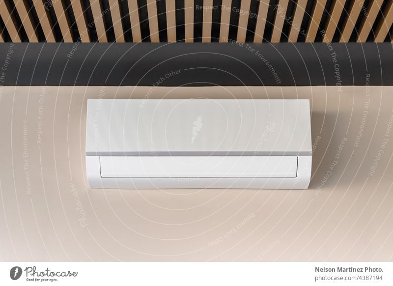 White air conditioner on beige wall cooler cold cooling heat ventilated temperature fan climate wind industry equipment isolated electronic wall-mounted blowing