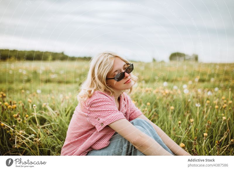 Tranquil stylish woman in summer field style trendy sunglasses tranquil serene meadow fashion female charming dreamy calm nature flower peaceful lawn enjoy