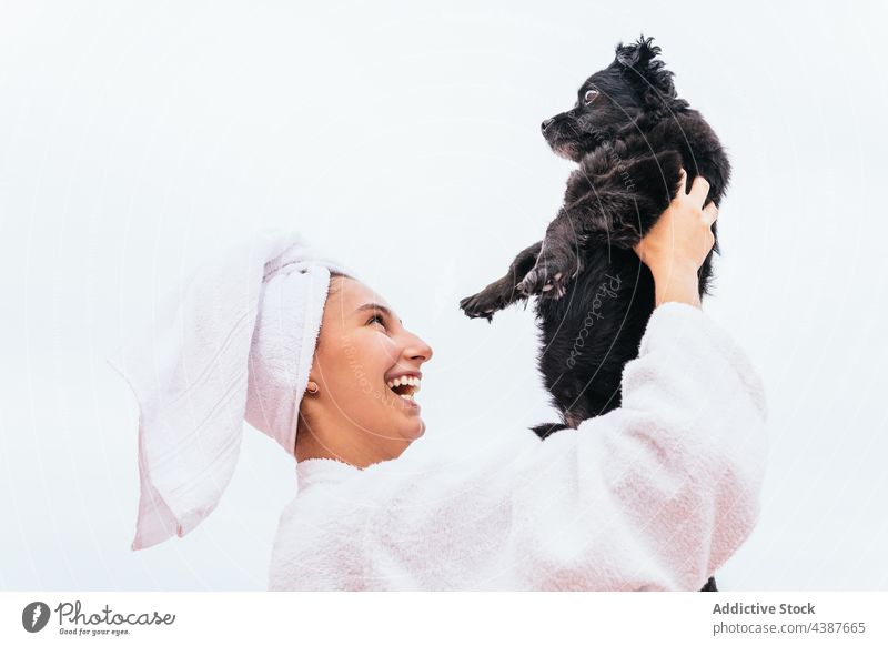Delighted female embracing dog after shower woman spa hug smile clean skin care hygiene pet owner young cheerful happy relax joy positive rest natural beauty