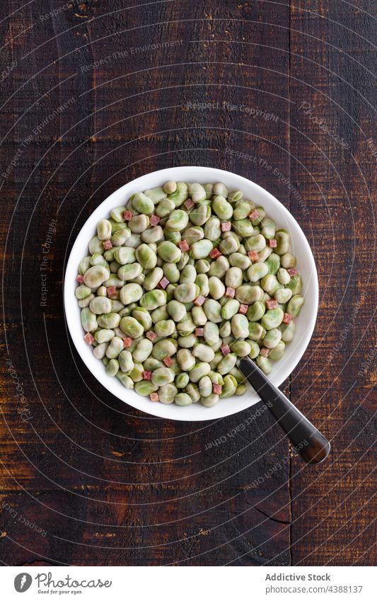 Bowl with frozen broad beans on table organic bowl natural healthy freeze cold nutrition rustic food serve pile culinary wooden cuisine product kitchen