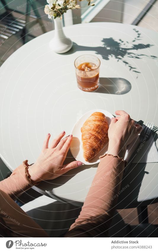 Anonymous Woman with coffee and croissant at table in cafe woman dessert delicious tasty drink beverage female french aromatic fresh enjoy beret pastry sweet