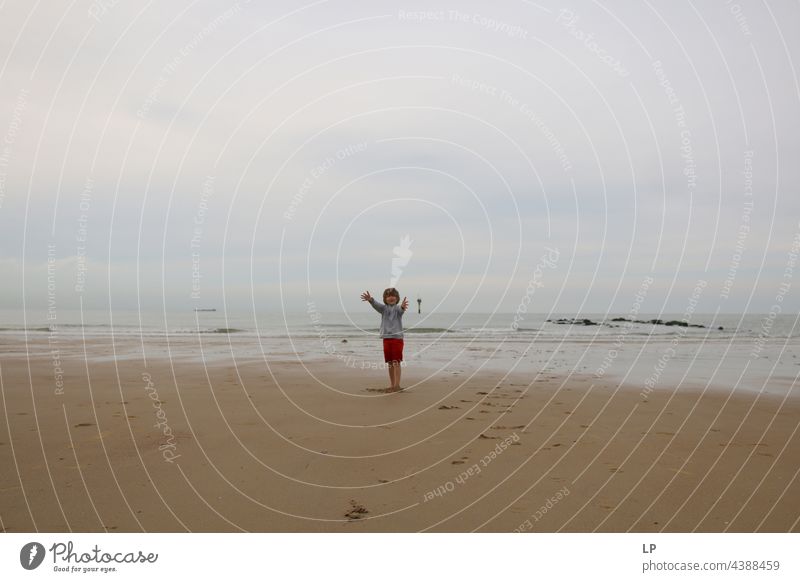 child alone on the beach with open arms towards the camera positive emotion smile Ocean Beach Risk Longing Individual Isolated Single Abstract Movement Flow