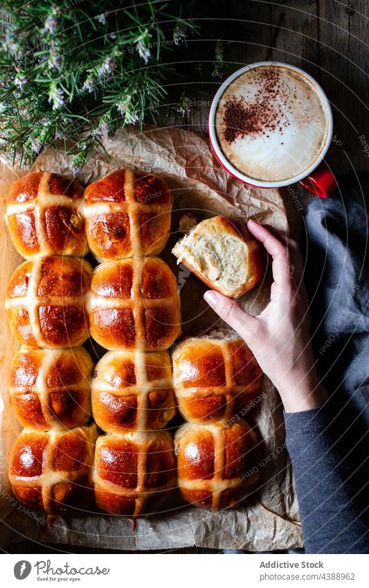 Hand with hot cross buns hand coffee glaze fresh food puff wheat baked soft grain flour bakery cereal organic breakfast dessert pastry sweet delicious tasty