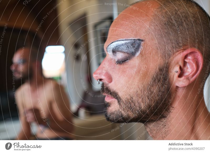 Drag queen man with makeup drag queen eyebrow cosmetic visage gender beard facial concept bisexual eyelid transgender male piercing appearance mirror
