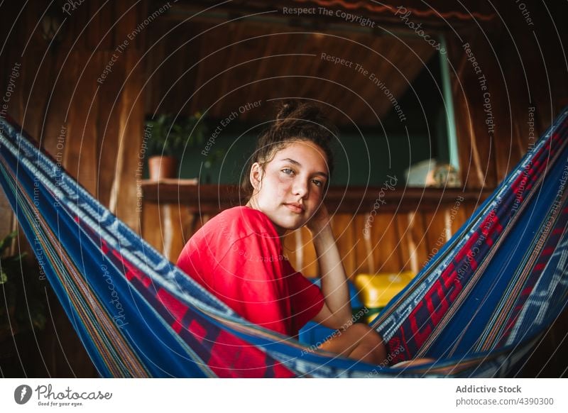 Young woman relaxing in hammock summer tropical travel chill vacation rest holiday female terrace young recreation calm tourism tranquil leisure harmony