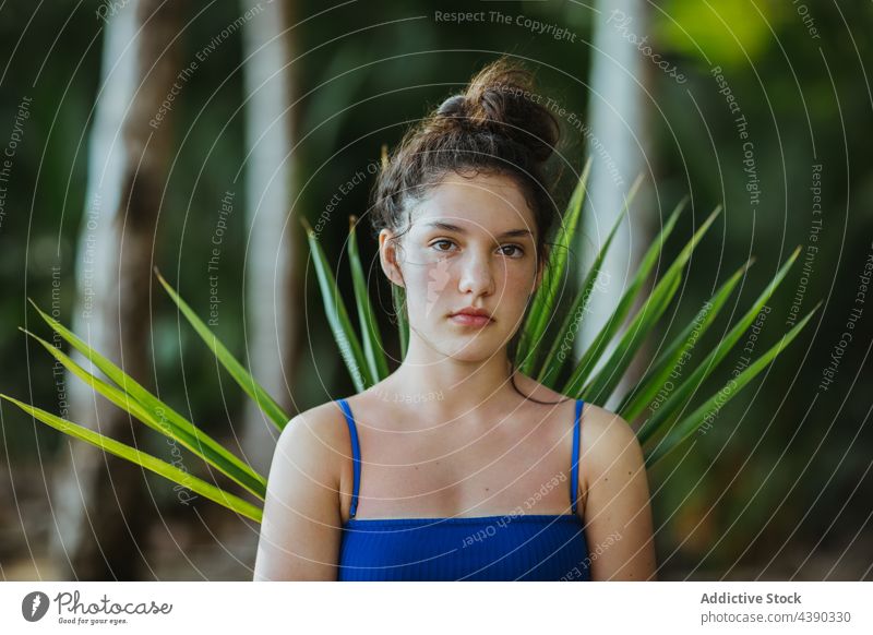 Peaceful woman standing in park with palm tree leaf garden tropical branch exotic nature summer female guanacaste uvita costa rica serene lush tranquil harmony