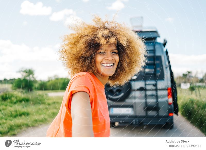 Black female traveler leading friend to camper woman road trip follow me smile summer countryside together longboard van happy ethnic black african american