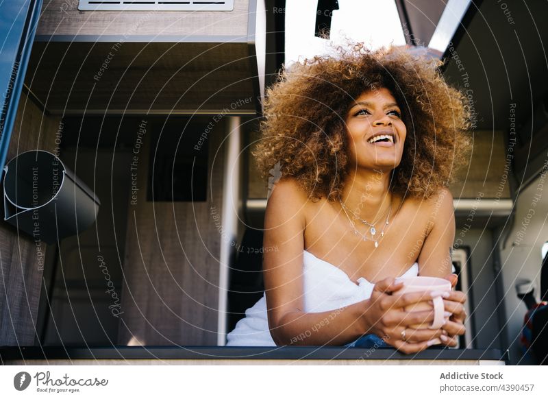 Black woman resting in caravan in morning weekend road trip summer hot drink modern traveler female young black african american ethnic relax recreation chill