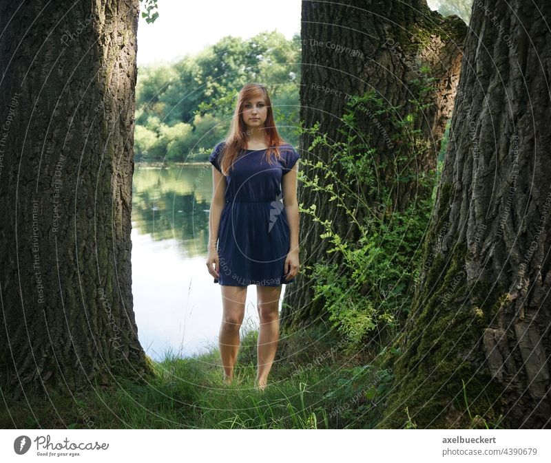 young woman in summer dress standing between trees at lake Young woman Summer Lake Swimming lake Water Swimming & Bathing Vacation & Travel Youth (Young adults)