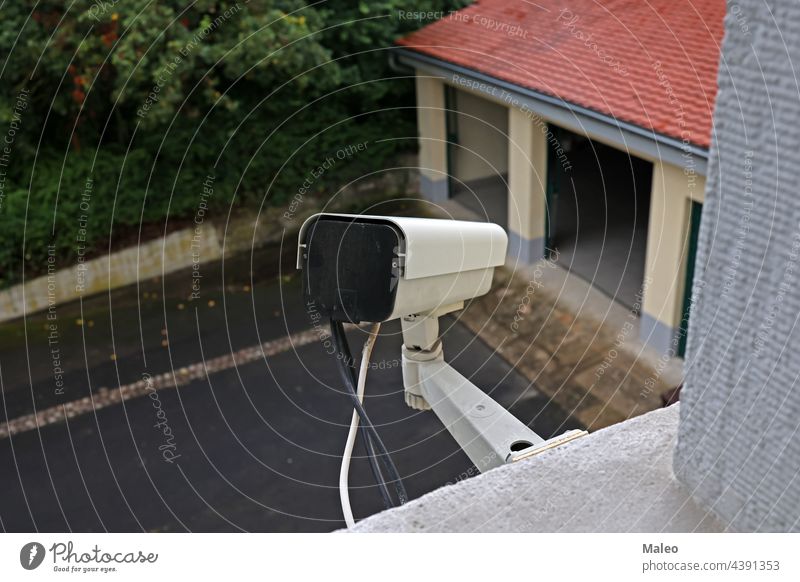 Video camera system on the wall of the building cable cctv circuit city control crime electronic equipment eyesight guard industry lens modern monitoring