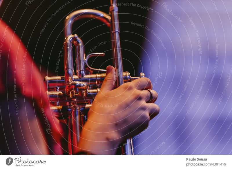 Close up hand holding a trumpet Trumpet Music Musician Musical instrument Jazz Close-up Artist Leisure and hobbies Playing Colour photo Concert Make music Sound